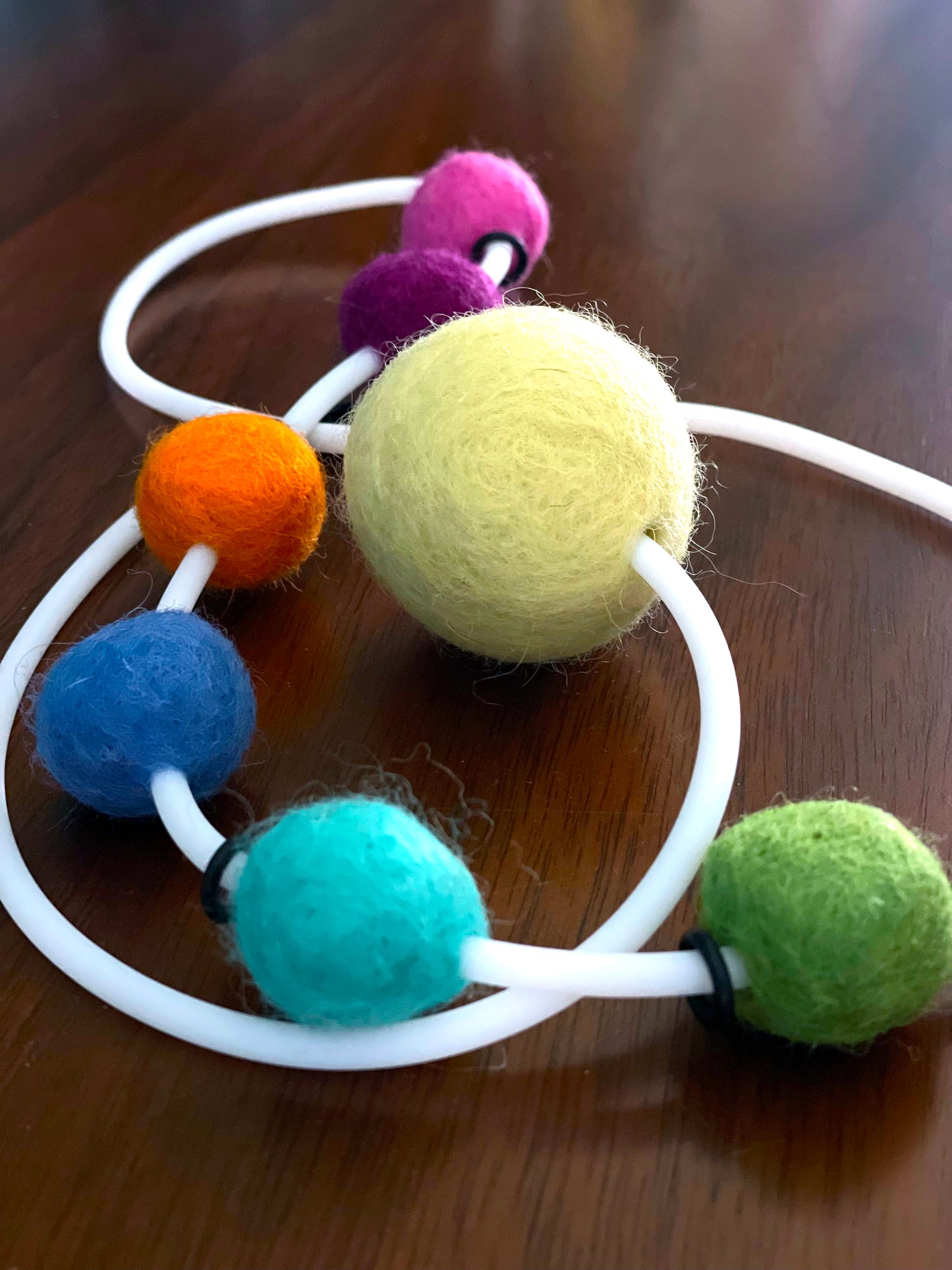 Modern Long Single Strand White Rubber Necklace With 7 Rainbow-Color Wool Felt Balls