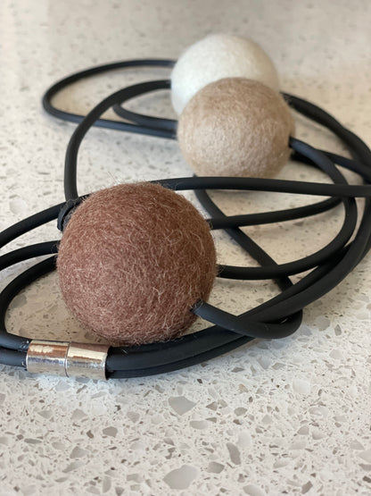 Modern Long Triple Strand Black Rubber Necklace With 3 Neutral-Color Wool Felt Balls